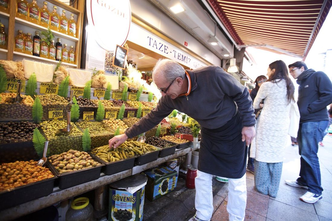 You can snack your way through the market, trying out samples from vendors like this olive stand.<br>